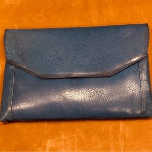 Blue fold over leather handbag made in Italy for Bloomingdales.